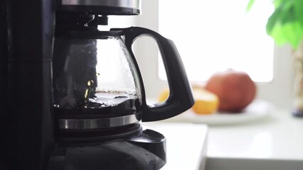 A drip coffee maker brewing coffee close-up