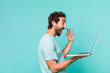 young adult hispanic crazy man with a laptop