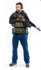 soldier, airsoft player in full gear with a machine gun. a man in headphones, a bulletproof vest, with a backpack and a full-length belt. White background.