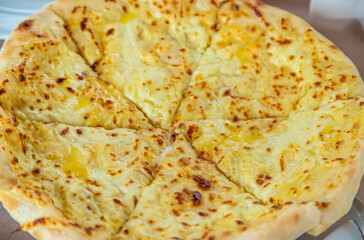 Georgian cuisine Megrelian khachapuri on the table. Selective focus.