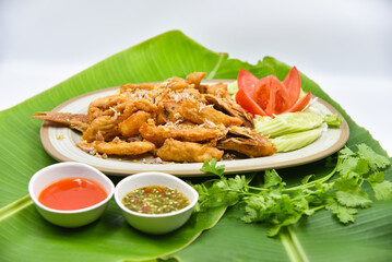 Deep-fried Red Tilapia Fish with Crispy Garlic - Thai food, top view on white background.