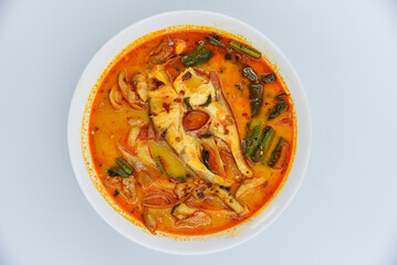Red Tilapia Fish In Clear Tomyum Soup - Thai food, top view on white background.