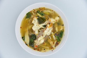 Red Tilapia Fish Spicy Soup - Thai food, top view on white background.