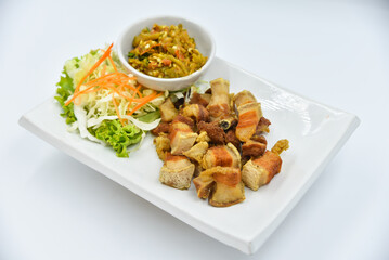 Deep-fried Pork Belly with Fish Sauce - Thai food, top view on white background.