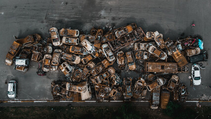 Irpin, Kyiv region,  Ukraine - 19.05.2022 , a lot of burnt shelled cars in the parking lot, the...