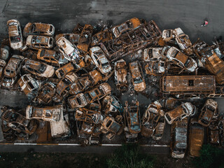 Irpin, Kyiv region,  Ukraine - 19.05.2022 , a lot of burnt shelled cars in the parking lot, the consequences of the invasion of the Russian army in Ukraine. War in Ukraine. Drone photo