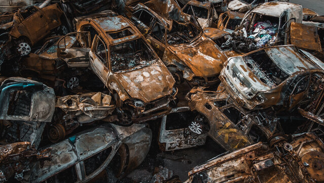 Irpin, Kyiv region,  Ukraine - 19.05.2022 , a lot of burnt shelled cars in the parking lot, the consequences of the invasion of the Russian army in Ukraine. War in Ukraine. Drone photo