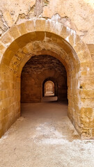 Obraz premium View of a vault inside of the Castello Maniace. Interior of the ancient citadel fortress Maniace Castle on island of Ortygia in Syracuse, Sicily, Italy, Europe EU. UNESCO World Heritage Site. Tunnel