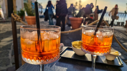 Typical Italian alcoholic aperitif (aperitivo) served in bar during sunset in the city center of...