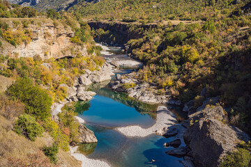 Fototapeta na wymiar Montenegro, Clean clear turquoise water of river Moraca in green moraca canyon nature landscape. Travel around Montenegro concept