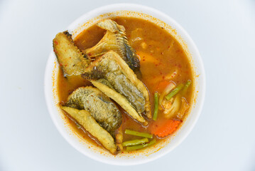 Sour Curry with Crispy Gouramy Fish - Thai food, top view on white background.
