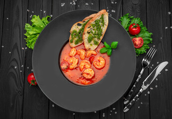 Seafood tomato soup bouillabaisse with croutons and pesto sauce