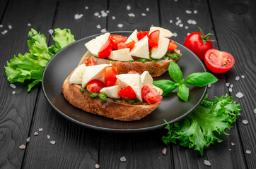 Bruschetta with cherry tomatoes, mozzarella cheese and pesto sauce.