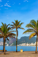 Fototapeta na wymiar Ipanema beach in Rio de Janeiro during a summer morning with the hills and city buildings in the background