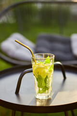 Top view Summer citrus lemonade with reusable metal straws on the black table outdoor, party in a backyard house with сold drink, summertime, eco friendly drinking straw.