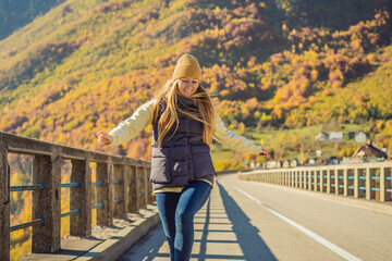 Montenegro. Woman touriste in background of Dzhurdzhevich Bridge Over The River Tara foggy morning....