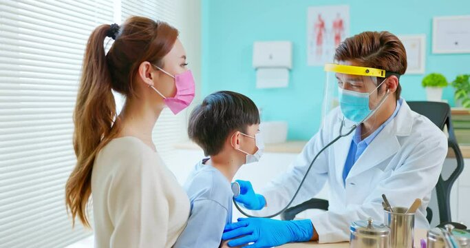 pediatrician examining sick boy