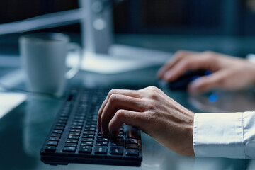 person is typing on the keyboard to explore the stock market.