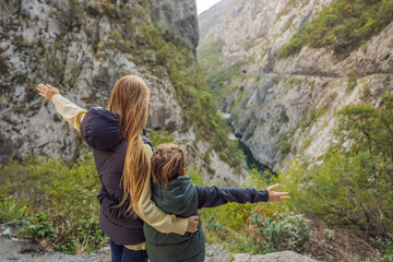 Mom and son tourists in the background of Beautiful Canyon of Moraca river in winter, Montenegro or...