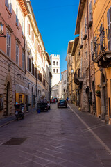 Fototapeta na wymiar ASSISI, ITALY, 6 AUGUST 2021: Ancient street in the historic center