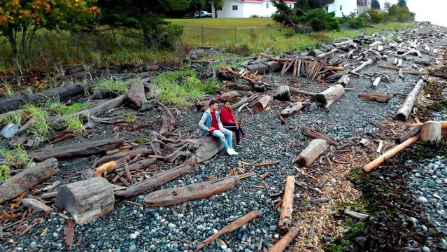 Vancouver Island, Canada, Quadra Island old historical lighthouse at Cape Mudge. couple in yellow rain coat during storm by the coast of Vancouver Island