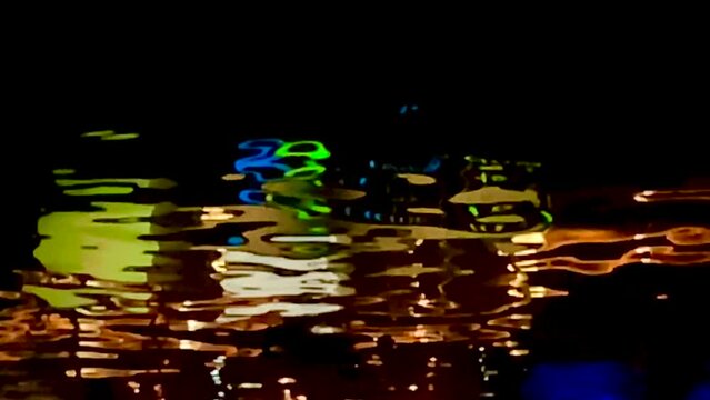 Reflection of the Clarke Quay sign in the Singapore river at night
