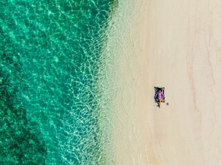 Beaches in the Maldives. Beautiful girl on the background of the sea and sandy beach. Travel and Tourism in the Maldives islands