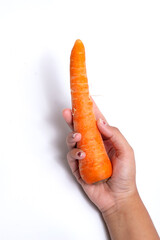 Orange carrot in the palm of the hand isolated on a white background.