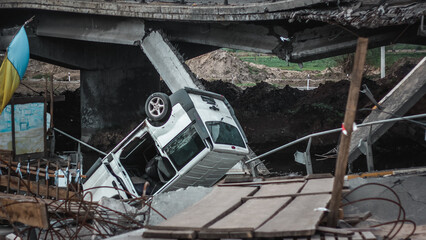 Irpin, Kyiv Oblast,  Ukraine - 19.05.2022: Cities of Ukraine after the Russian occupation. destroyed car near bridge during the evacuation from the city of Irpin, northwest of Kyiv
