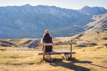 Montenegro. Woman tourist on the background of Durmitor National Park. Saddle Pass. Alpine meadows. Mountain landscape. Travel around Montenegro concept