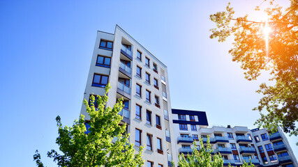 Apartment residential house and home facade architecture and outdoor facilities. Blue sky on the background. Sunlight in sunrise.