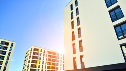 Apartment residential house and home facade architecture and outdoor facilities. Blue sky on the background. Sunlight in sunrise.