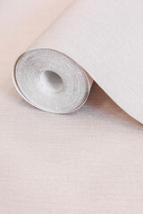 a rolled-out roll of vinyl wallpaper lying on the floor