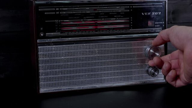 Antique radio receiver. Tuning the radio station