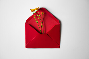 Red envelope on a gray background. Inside is a yellow flower.