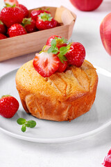 Semolina cake or mannik topped with apple, strawberry and mint. Fruits and berries in the background on the white table. Soviet cuisine dessert