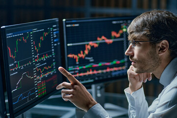 businessman comparing stock market data late in the evening .