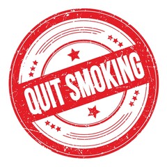 QUIT SMOKING text on red round grungy stamp.