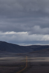 A solitary road through the rough Icelandic landscape.