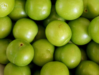 top view close-up organic green plums 
