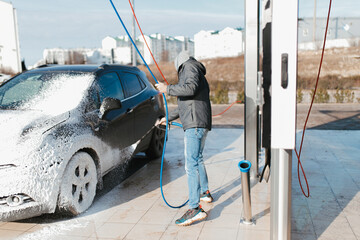 Washing car on a self-service car wash.