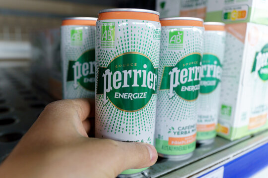 Tyumen, Russia-May 11, 2022: Mineral water bottles Perrier energize cofeine yerba mate. French brand of premium mineral water. Selling in the hypermarket