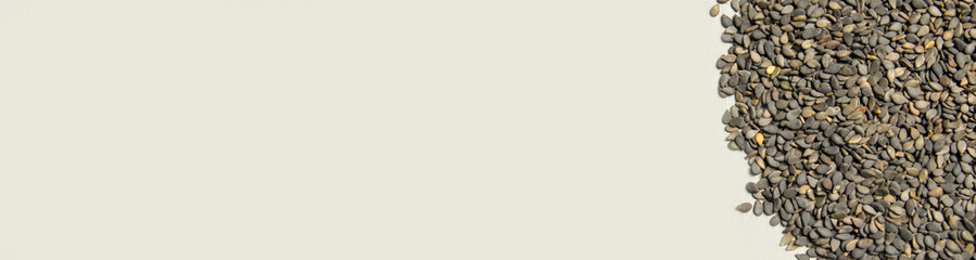 black sesame seeds close up. background with the image of black sesame. Banner for insertion into site. Place for text cope space.