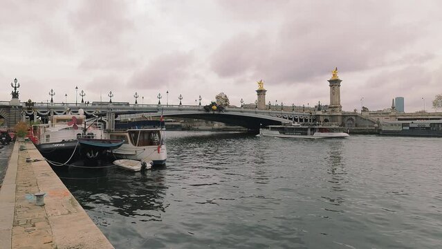 Boat passing under Pont Alexandre III on the river Seine, Paris, France.