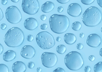 Blue doses of acid, hyaluronic moisturizing serum or gel on a monochrome background making pattern. Abstract backdrop. Beauty product wallpaper. Cosmetics, healthcare protection concept. 