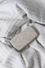 Pumice stone on white spa towel