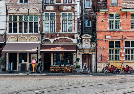 Old street with tables of cafe in Ghent (Gent), Belgium. Architecture and landmark of Ghent. Cozy cityscape of Ghent.