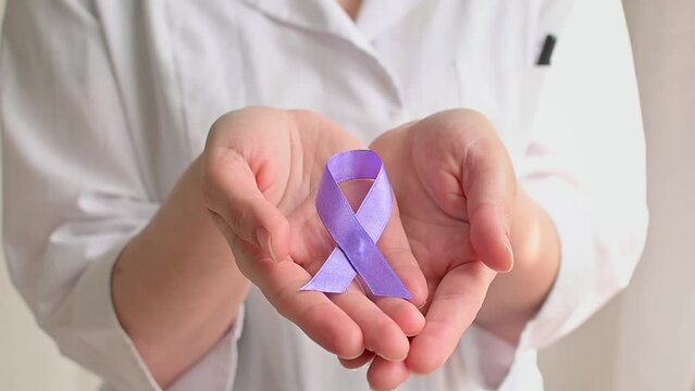 International Epilepsy Day. Doctor in coat holds Purple ribbon. Alzheimer's disease, Pancreatic cancer, Hodgkin's Lymphoma awareness