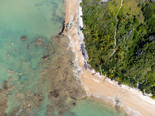 Amazing paradisiacal and deserted beach with clear blue waters and visible corals at low tide - Cumuruxatiba, Bahia, Brazil - aerial drone view