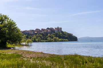 Fototapeta na wymiar Lake Bracciano, Italy and the town of Anguillara Sabazia in the background.